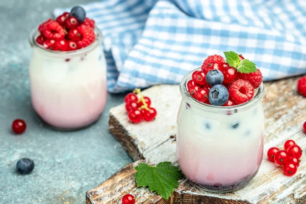 Healthy layered dessert with yogurt, jam, red currant and blueberries. Natural detox. banner, menu, recipe place for text, top view.