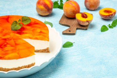 Layered cheesecake piece with peaches, peache jelly, jam. delicious sweet dessert piece of cheesecake. Homemade cream cake with peaches,