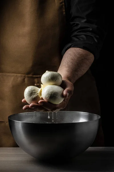 The processing Traditional Italian mozzarella, Cheesemaker, showing freshly made mozzarella,