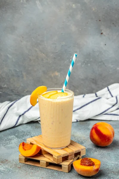 Yogurt with peaches. Summer breakfast drink, fresh blended peach smoothie, vertical image place for text.