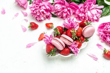 pink macaron or macaroon cakes with peony rose on a light background. Banner, flyer, beautiful postcard, top view,
