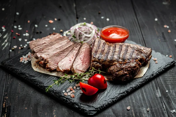 Beef steak. Grilled meat. Dry Aged Barbecue Ribeye Steak on wooden background. banner, menu, recipe place for text, top view.