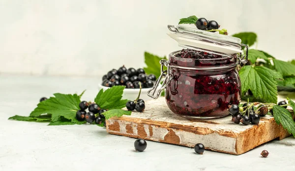 Delicious black currant jam urd, custard or jam and fresh berries, Long banner format, top view.