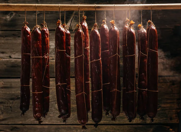 The process of smoking hanging sausages in the smokehouse.