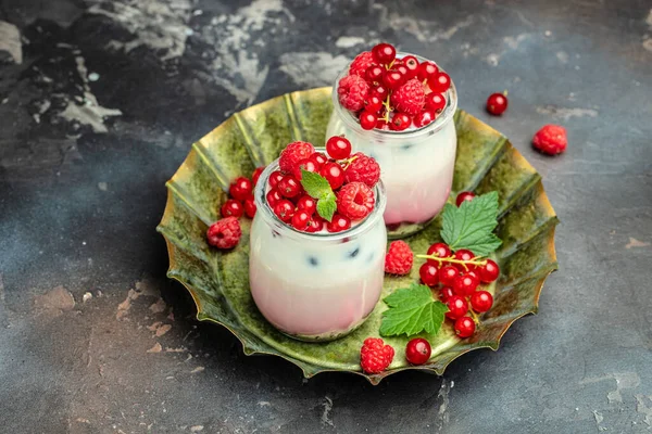 raspberries yogurt. Healthy breakfast Greek yogurt with raspberries and mint in a glass. Berry smoothie. healthy dieting concept.
