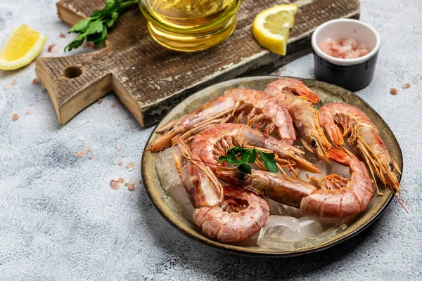 Shrimps, prawns. Seafood Red Argentine shrimps with ice on a light background, Wild shrimps, ocean jumbo shrimps. Long banner format. top view.