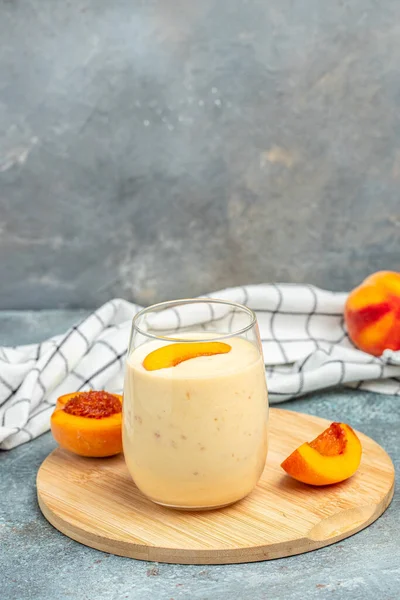 yogurt peaches breakfast drink, fresh blended peach smoothie, vertical image place for text,