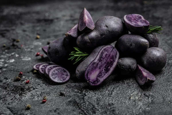 Organic purple sweet potato. Raw sweet potatoes or batatas. pomoea batatas. Batata potato, vegan food ingredient. banner, menu, recipe place for text, top view,