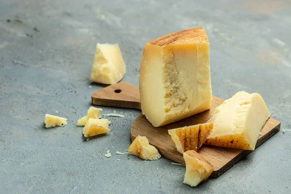 gruyere cheese, a traditional Swiss hard yellow cheese without holes, with a dark crust and a pleasant floral and nutty aroma, place for text, top view,