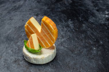 Beyaz ve mavi küflü krem peynir, camambert peyniri. Koyu arkaplanda krem peyniri, üst görünüm,