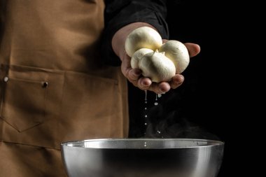 Ev yapımı peynir üreticisi taze biyo sütle el yapımı mozzarella üretir. Mozzarella yapma süreci. İtalyan sert peynirli silano veya peynirci ellerinde caciocavallo..