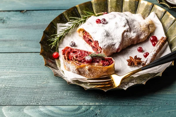 Strudel with a cherry. winter dessert strudel with cherry, cranberries and walnut. Food recipe background. Close up.