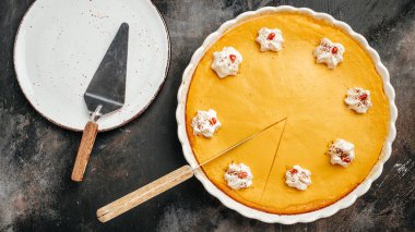 Homemade pastry pumpkin cheesecake, Pumpkin Pie with whipped cream for Thanksgiving Day. banner, menu, recipe place for text, top view.