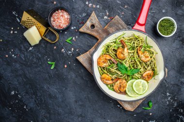 Kabaklı makarna, karides ve tavada pesto sosu. Keto düşük karbonhidrat diyeti. afiş, menü, metin için tarif yeri, üst görünüm.