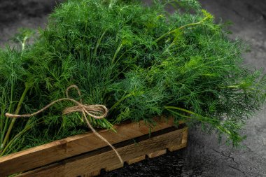 Ahşap kutuda bir sürü dereotu var. Vejetaryenler için yemek. Uzun afiş biçimi. en üstteki görünüm.