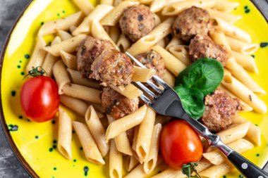 Köfteli makarna ve gri arka planda baharatlı domates sosu. Restoran menüsü, diyet, yemek kitabı tarifi afişi, metin yeri, üst görünüm.