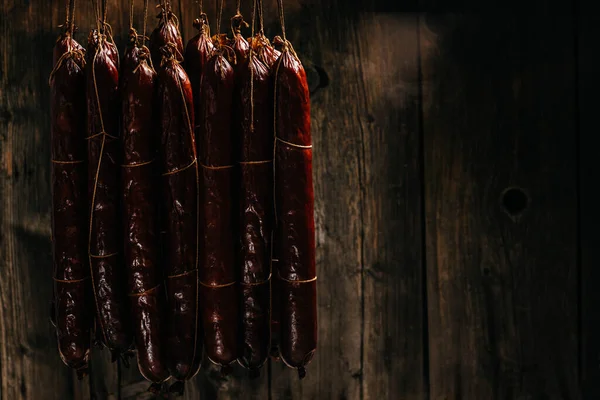 stock image Process of smoking sausage hang in a cupboard with smoke. Clouds of smoke rise up and envelop the sausages hanging in a row.