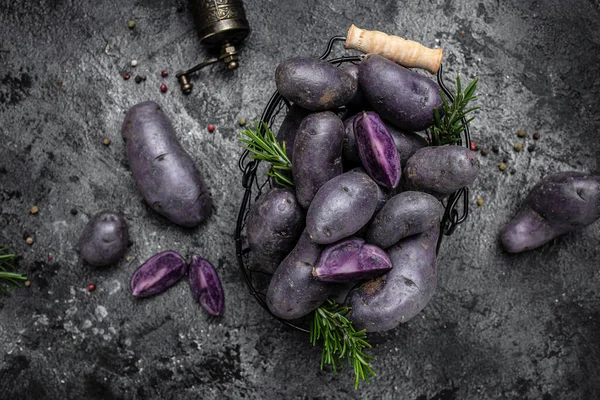 Organic purple sweet potato. Raw sweet potatoes or batatas. pomoea batatas. Batata potato. vegan food ingredient. banner, menu, recipe place for text, top view.
