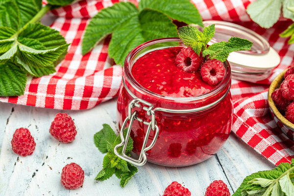 raspberry jam marmalade with fresh raspberries and mint. Organic Raspberry. Red berry. banner, menu, recipe place for text, top view.