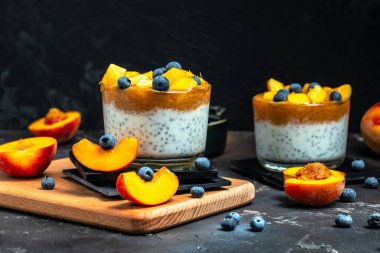 peaches blueberry chia yogurt. Homemade dessert with fruits. place for text, top view.