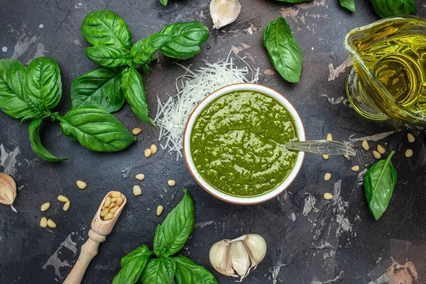 Fresh Italian pesto sauce with basil, pine nuts, parmesan cheese. Long banner format. top view.