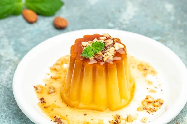 caramel panna cota. Creme Caramel Dessert on a blue background. banner, menu, recipe place for text, top view.