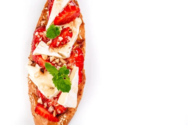 Bruschetta with strawberries, cheese camembert nuts and honey isolated on a white background. banner menu recipe place for text.