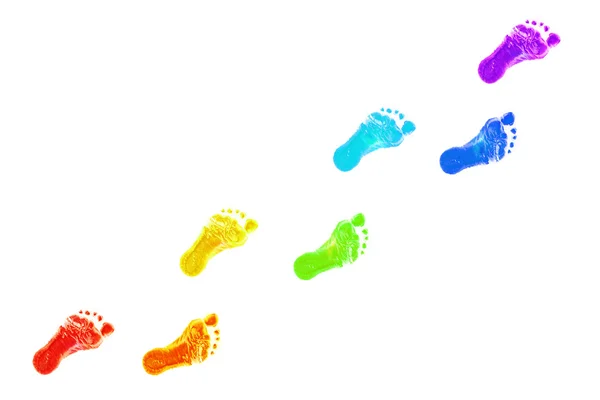 Babyfuß druckt alle Farben des Regenbogens. Stockbild