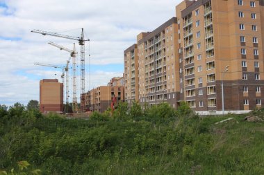 Russia, Novosibirsk 10.06.2021: construction of multi-storey modern buildings for the city with houses crane on an industrial site
