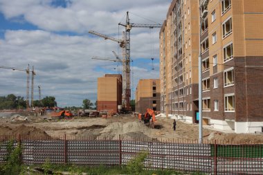 Russia, Novosibirsk 10.06.2021: construction of multi-storey modern buildings for the city with houses crane on an industrial site