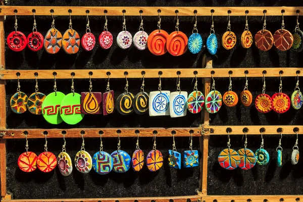 Colorful set of earring on wood stand — Stock Photo, Image