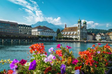 Lucerne 'deki ünlü turistik ve seyahat merkezi. Jesuitenkirche Kilisesi ve Reuss Nehri. Çiçekli ahşap şapel köprüsü olan liman manzaralı, Luzern, İsviçre, Avrupa