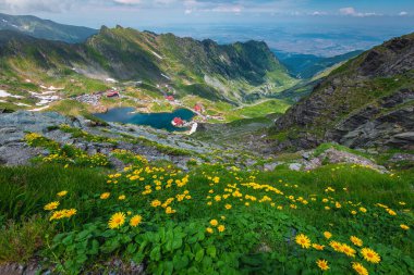 One of the most visited lake and hiking place in the Carpathians. Famous lake Balea and chalets on the shore of the lake, Fagaras mountains, Carpathians, Romania, Europe