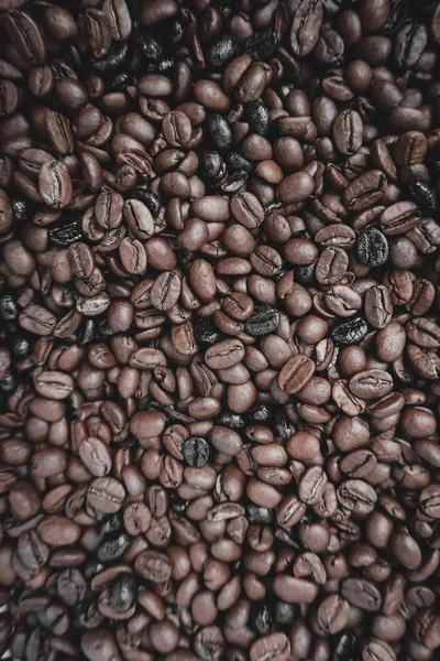roasted coffee beans, brown background