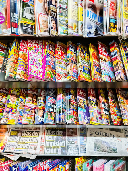 Hamburg, Germany - 05. February 2022: Many German illustrated newspapers with current celebrity news on a store shelf - magazine brands such as Bild Zeitung, Tina, Neue Post