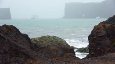 Strong surf at the basalt rocks of dyrholaey on Iceland.