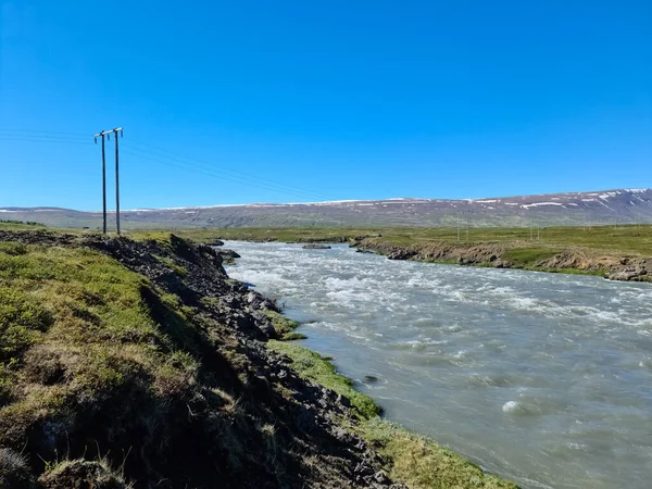 Fantastic landscape with flowing rivers and streams with rocks and grass in Iceland