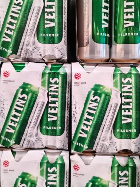 Kiel, Germany - 20. August 2022: Numerous cans of Veltins beer on a supermarket shelf