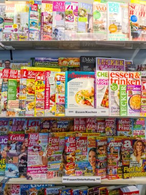 Kiel, Germany - 20. August 2022: A large shelf of German illustrated magazines in a supermarket 