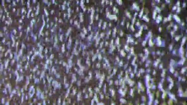 Close up view at a plasma tv while showing television white noise.