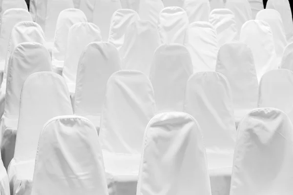 Chairs with white covers Stock Image