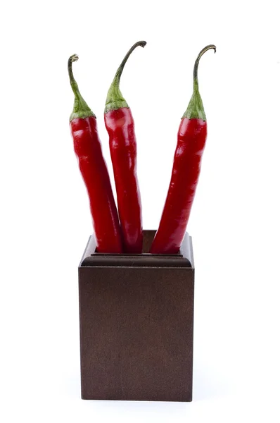 The top three chili peppers in a wooden cup — Stock Photo, Image