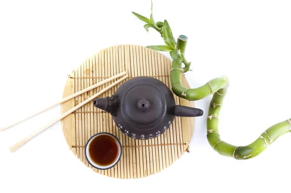 Tea set and a branch of bamboo — Stock Photo, Image