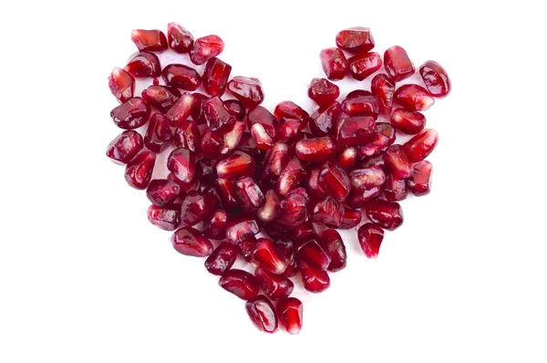 Pomegranate seeds in heart shape isolated — Stock Photo, Image