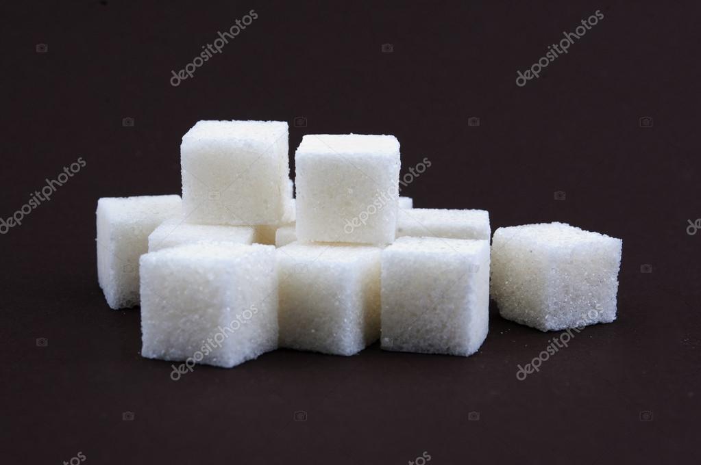 Bunch Of White Lump Sugar On A Brown Background Stock Photo