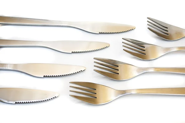 Serie de tenedores y cuchillos uno contra el otro — Foto de Stock