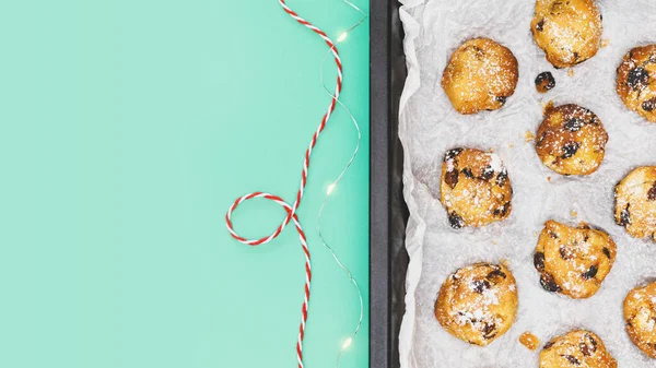 Traditional Christmas pastry on a baking sheet on a mint background — Stock Photo, Image