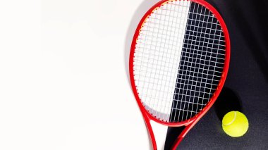 Tennis racket and a ball on a black and white background