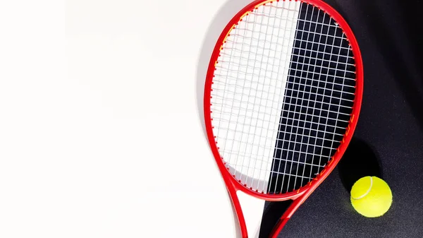 Tennis racket and a ball on a black and white background — Stock Photo, Image