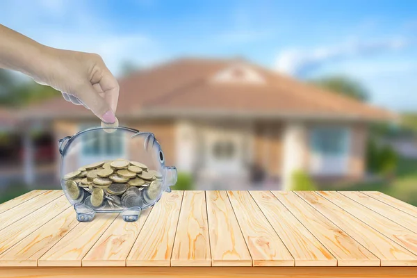 Real estate sales, home savings, housing loan market ideas, mortgage plans, housing industries and tax saving strategies. Piggy bank housing isolated outside the house on the background.